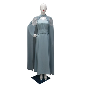 Detail view of silver sequins and tassels on the shoulder of the grey-blue gown cape