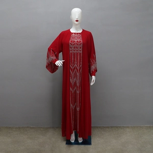 Detail of red chiffon abaya showing silver geometric rhinestone patterns and wide cuffs