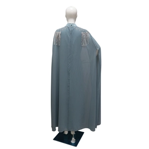 Detail of greyish blue chiffon dress with silver beads and long fringe on shoulders