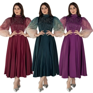 Detailed view of high-neck satin jalabiya gowns with sequin embroidery and lantern sleeves