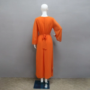 Detail of silver rhinestone embellishments on the side of this orange chiffon maxi dress