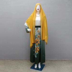 Detail of floral print and rhinestone accents on gradient long kaftan robe with yellow hijab