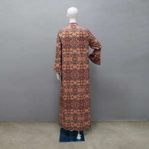 Detail view of ethnic Abaya back with complex geometric patterns and orange floral prints