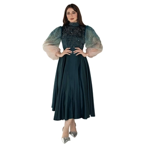 Detail of beaded embroidery and gradient puff sleeves on this green jalabiya gown