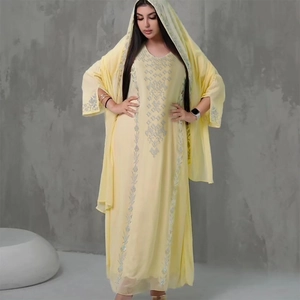 Detail of silver sequin embroidery on light yellow kaftan dress and matching headscarf