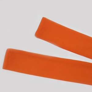 Detail view of two bright orange plush soft fabric headbands on white background
