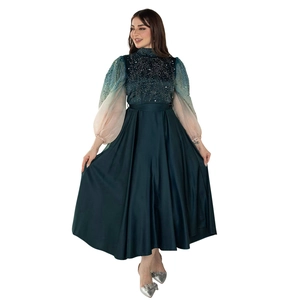 Detail of jalabiya gown featuring rhinestone embroidery and gradient puff sleeves
