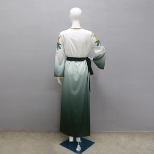 Detail of gradient robe with floral patterns and yellow wavy lace on cuffs and neckline