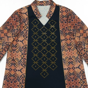 Detail of bohemian geometric print and gold rhinestone diamonds on navy blue ethnic robe