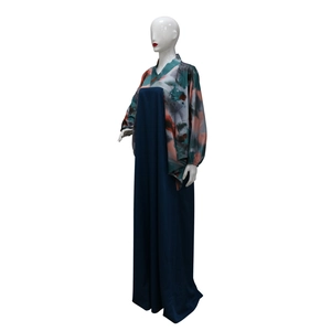 Detail eines Fledermausärmel-Kaftans mit abstraktem Druck und langem dunkelblauen Kleid