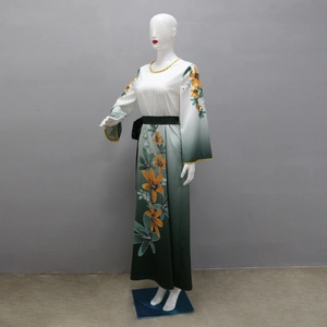 Detailed macro view of orange lily prints and vertical gradient fabric on long sleeve robe
