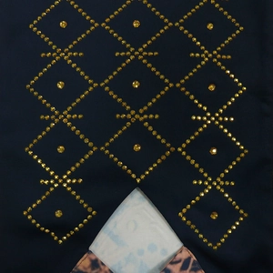 Detail of dark blue fabric with geometric golden rhinestone diamond patterns