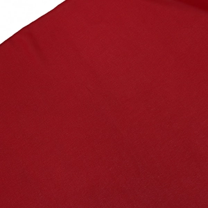 Close-up detail of smooth red flat-weave fabric texture on the two-piece kaftan robe