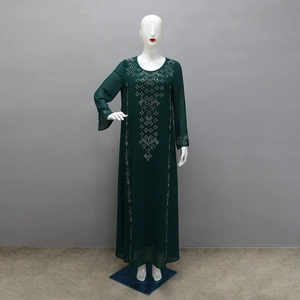 Detailed view of silver geometric rhinestone embroidery on dark green Abaya maxi dress
