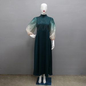 Detailed close-up of dark green jalabiya with gold sequins and gradient puff sleeves
