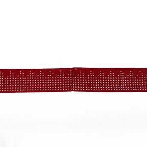 Detail of red fabric belt with decorative rhinestone rows in zigzag pattern