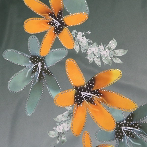 Macro detail of floral print fabric featuring sparkling silver rhinestones on vibrant petals