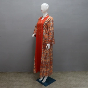 Detail of ethnic long robe with orange blue print and gold bead embroidery on red panel