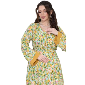 Detail of floral long dress showing V-neckline with yellow trim and buttoned bodice
