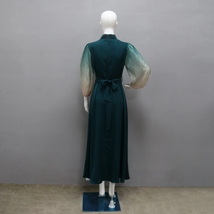 Detail of teal gradient lantern sleeves with shimmering rhinestones on a long jalabiya dress