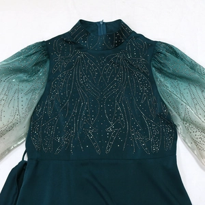 Detail of jalabiya gown featuring rhinestone patterns and gradient sheer puff sleeves
