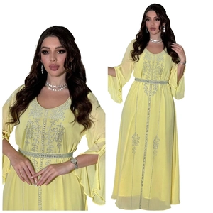 Detail of yellow chiffon kaftan dress with sparkling silver rhinestones and ruffle sleeves