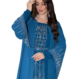 Detail of silver rhinestone geometric patterns on deep blue chiffon abaya sleeves