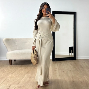 Elegant beige long sleeve maxi dress with O-ring waist detail and flared cuffs