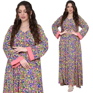 Close-up of vibrant floral print dress with pink V-neck trim and elegant long sleeves
