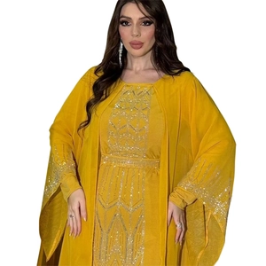 Close-up of silver sequin and bead embroidery on yellow Middle Eastern kaftan