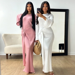Detail of waist ring buckle and elegant pleated draping on long sleeve maxi dresses