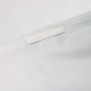 Detail of grey fabric with fine twill texture and matching loop handle on the stitched edge