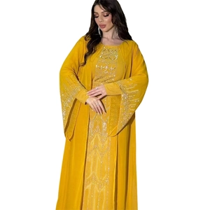 Detail of yellow abaya featuring intricate sequin embroidery and decorative rhinestones