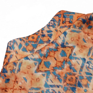 Detailed macro view of ethnic robe neckline with orange and blue geometric patterns