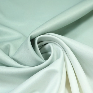 Detailed texture of light green satin robe fabric with smooth silk finish and elegant folds