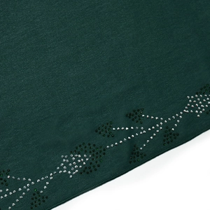 Detail of dark green robe with intricate silver rhinestone vine pattern and fabric texture