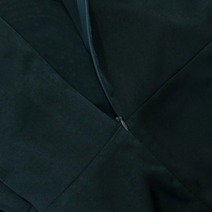 Detailed macro view of dark green velvet jalabiya with invisible zipper and fine stitching