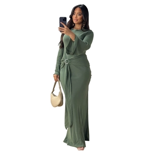 Detail of dark green dress with metal ring buckle, pleated drape and flared sleeves