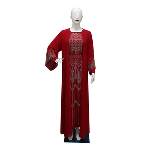 Detail of red chiffon robe with silver rhinestone patterns on waist and wide cuffs
