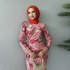 Close-up of stylish paisley print long sleeve dress with a vibrant orange headscarf