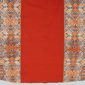 Detail of ethnic geometric print fabric with hot-fix rhinestones and gold trim