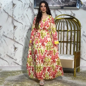 Floral maxi dress with V-neckline and waist tie on an elegant marble background