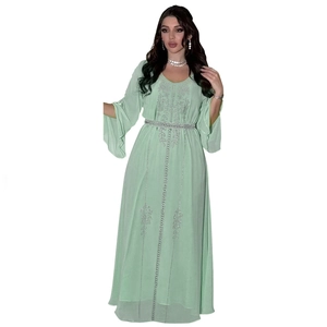 Detail of mint green chiffon dress with silver rhinestone embroidery and bell sleeves
