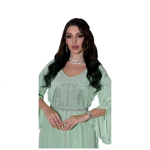 Detail of mint green chiffon kaftan with silver sequins and beaded embroidery patterns