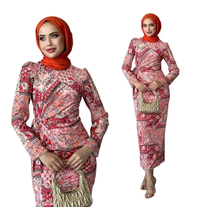 Detail of paisley print dress with side waist tie and matching orange hijab set