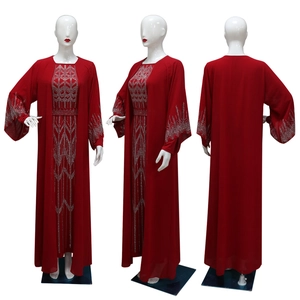 Detail of red chiffon abaya with silver rhinestone patterns on chest and cuffs