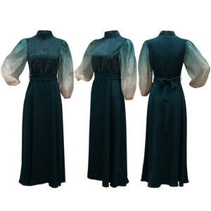 Detailed close-up of emerald green jalabiya with rhinestone embellishments and ombre puff sleeves