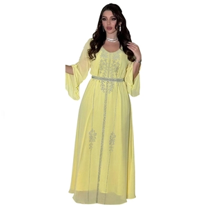Detail of yellow chiffon kaftan with silver rhinestone floral embroidery and beaded belt