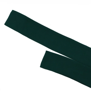 Detail of dark green fabric belt with fine stitching and soft stretch texture
