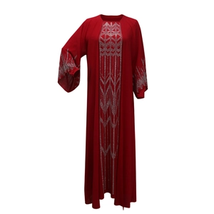Detail of red chiffon abaya with intricate silver rhinestone geometric patterns on the neckline